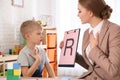 Speech therapist working with little boy Royalty Free Stock Photo