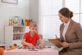 Speech therapist working with little boy Royalty Free Stock Photo