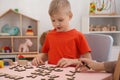 Speech therapist working with little boy Royalty Free Stock Photo