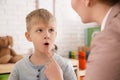 Speech therapist working with boy in office Royalty Free Stock Photo