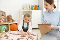 Speech therapist working with little girl Royalty Free Stock Photo