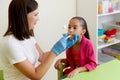 Speech therapist working with girl training pronunciation Royalty Free Stock Photo