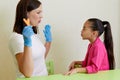 Speech therapist working with girl training pronunciation Royalty Free Stock Photo