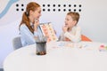Speech therapist teaching boy articulation during a session Royalty Free Stock Photo