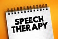 Speech Therapy - training to help people with speech and language problems to speak more clearly, text concept on notepad