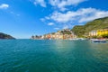 A speed boat crosses the colorful harbor of the village of Portovenere, Italy, on the Ligurian Coast near Cinque Terre Royalty Free Stock Photo