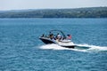 Speed boat with people on Skaneateles Lake, New York