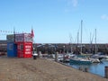 speed boat rides kiosk on Scarborough harbour with boats and fishing equipment Royalty Free Stock Photo
