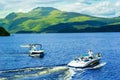 Speed boat with tourists on Summer at Loch Lomond, Luss, Scotland Royalty Free Stock Photo