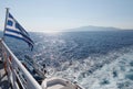 Speed boat traces on water in the Aegean sea. Boat and flag of Greece in motion. Europe Royalty Free Stock Photo