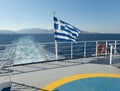 Speed boat traces on water in the Aegean sea. Boat and flag of Greece in motion. Europe Royalty Free Stock Photo