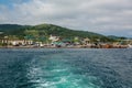 View on shore from the boat. Trail on sea water surface behind boat. Royalty Free Stock Photo