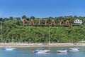 Speed boats and Pattaya city alphabet sign on the Pratumnak hill at Pattaya bay background and blue sky, Pattaya, Thailand