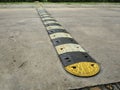 Speed bump on a concrete road Royalty Free Stock Photo