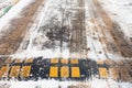 Speed bump in snow on urban road in winter