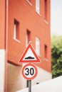 speed bump to limit speed of cars traffic sign. 30 kph and speed bump road traffic signs in italian city, europe Royalty Free Stock Photo