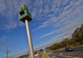 Speed camera mounted high on a pole stands on the centre medium strip major road Melbourne