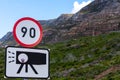 Speed and camera trap road sign with mountain background. Royalty Free Stock Photo