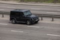 Luxury car black Mercedes Benz speeding on empty highway