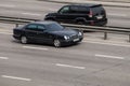 Luxury car black Mercedes Benz speeding on empty highway