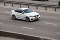 Luxury car white BMW speeding on empty highway