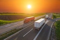 Speed delivery trucks on the empty highway at sunset Royalty Free Stock Photo