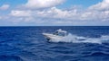 Speed fishing tender boat jumping the waves in the sea and cruising the blue ocean day in Bahamas. Blue beautiful water