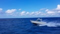 Speed fishing tender boat jumping the waves in the sea and cruising the blue ocean day in Bahamas. Blue beautiful water Royalty Free Stock Photo