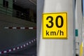 Speed limit 30km/h traffic sign on yellow on building Royalty Free Stock Photo
