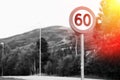 60 speed limit road sign with light leak background