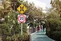 Speed limit road signs with biker background.Traffic signs warning drivers that conditions ahead may make it unsafe to drive. Royalty Free Stock Photo