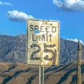 Speed limit sign against fence mountain and sky Royalty Free Stock Photo