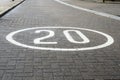 Speed Limit Sign Painted on a Cobbled Urban Road