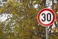 Speed limit thirty sign next to a school park Royalty Free Stock Photo