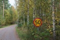 Speed limit traffic sign by a gravel road Royalty Free Stock Photo