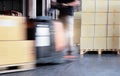 Speed motion blur of forklift driver loading shipment boexs at the warehouse. Royalty Free Stock Photo