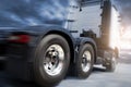 Speed motion blur of semi truck driving with spinning wheels on road. Industry freight truck transportation. Royalty Free Stock Photo