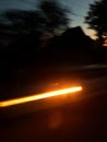 Speed in motion. Car light at night street. City in sunset light. Royalty Free Stock Photo