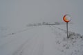 speed sign with 70 kph covered in snow