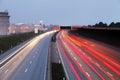 Speed Traffic at Dramatic Sundown Time - light trails on motorway highway at night, long exposure abstract urban background