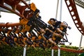 Speed turn, people riding a roller coaster at amusement park