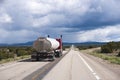 Speed up red semi truck rig with tank trailer on long road in Ne Royalty Free Stock Photo