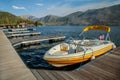 Yellow Speedboat on Mountain Lake