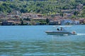 Speedboat crosses Lake Iseo view from ferry with Monte Isola on the background. Italian landscape. Island on lake. Royalty Free Stock Photo