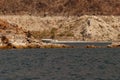 Speedboat driving at Lake Mead with low water line visible in white Royalty Free Stock Photo