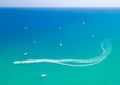 Speedboat leaves spray trail on sea water. Watersports at seaside, aerial seascape