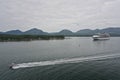 A speedboat races past a cruise ship in the Tongass Narrows