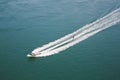 A speedboat with water skier on the Menai Strait