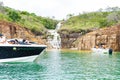 Speedboats and tourists at the Blue Lagoon Waterfall