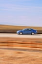 Speeding Blue Car with Blurred Background Royalty Free Stock Photo